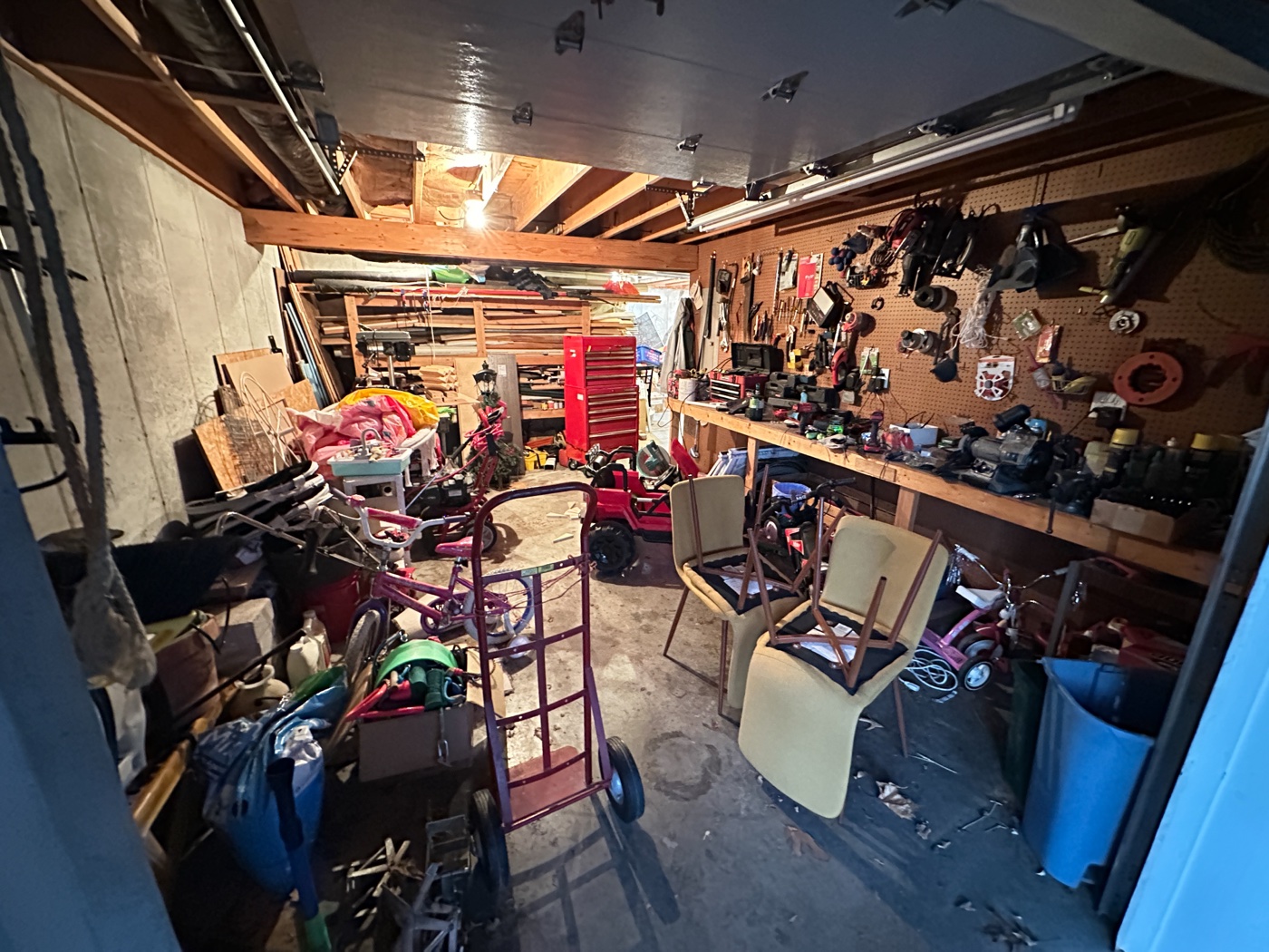 Jim's 12&times;20 shop before &mdash; dark, cluttered, blocked floor space