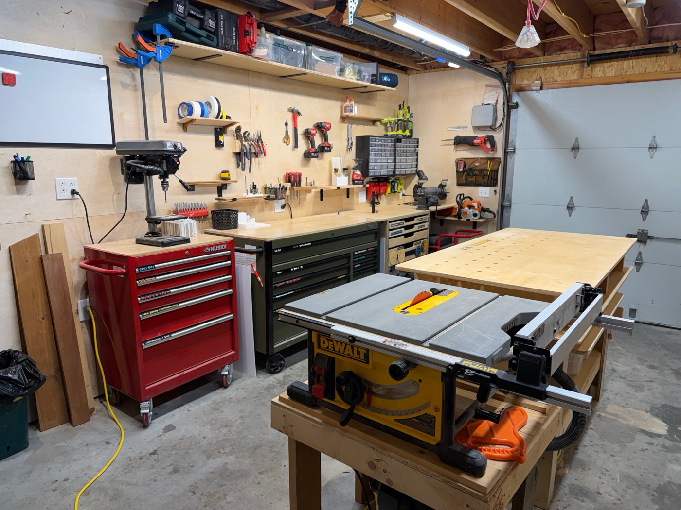 Main workbench area with table saw and drill press