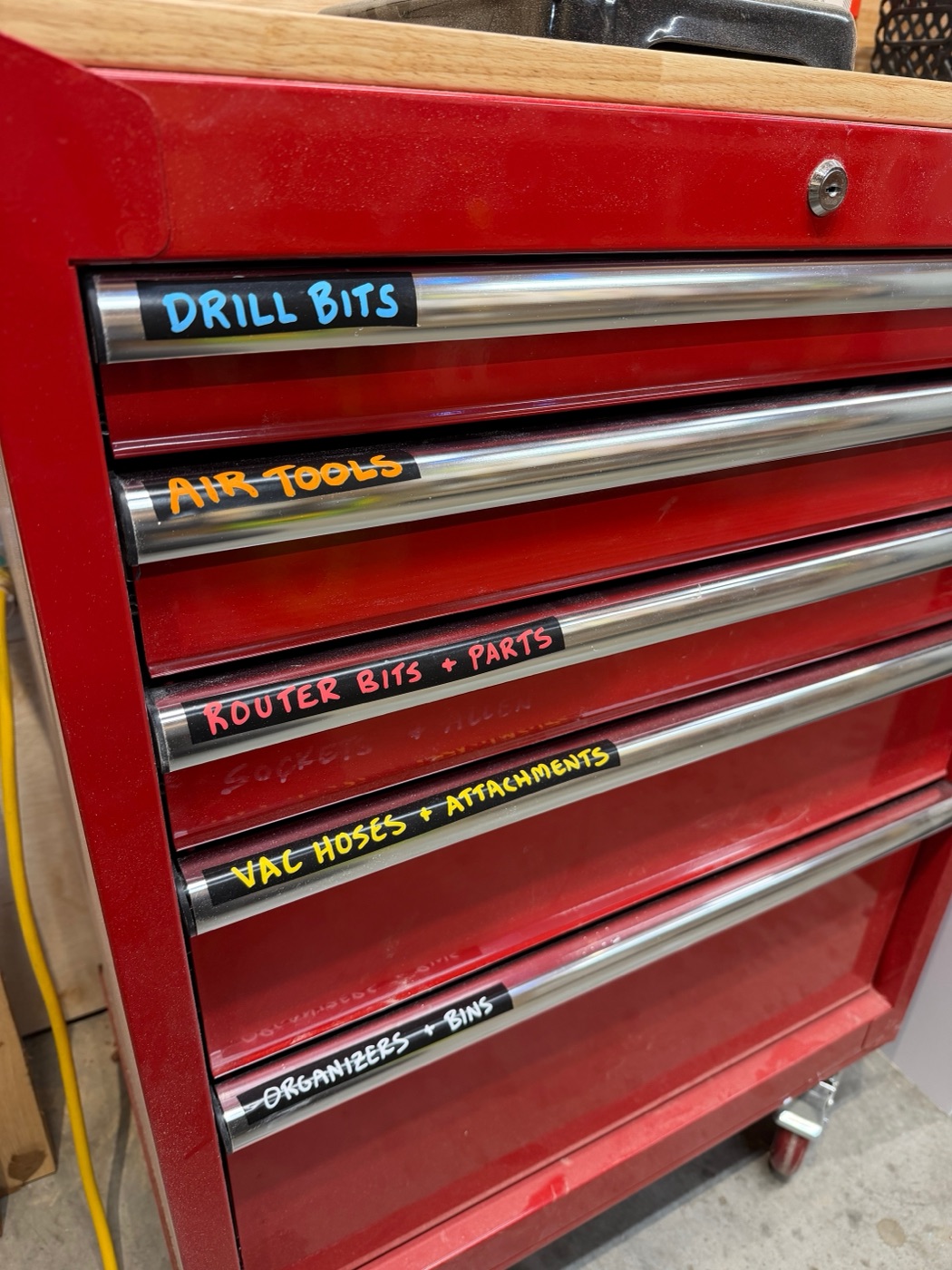 Red rolling tool chest with labeled drawers