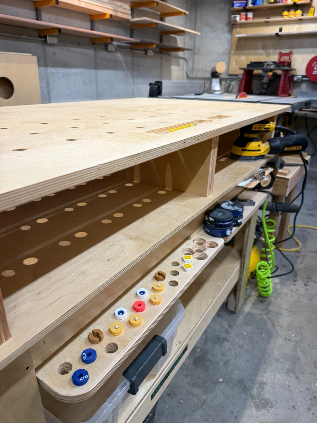Workbench front with dog storage rail