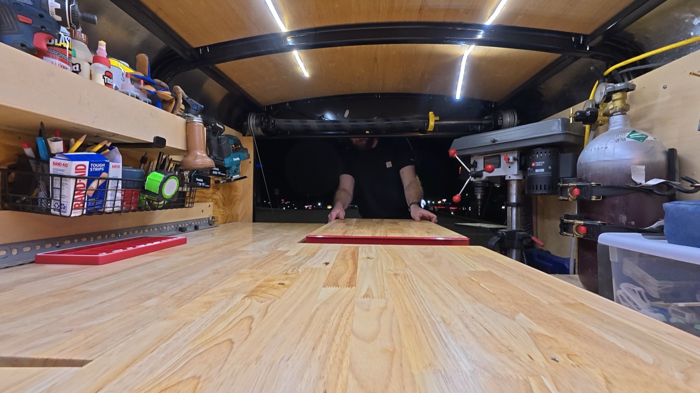 Center aisle with rolling carts between workbenches