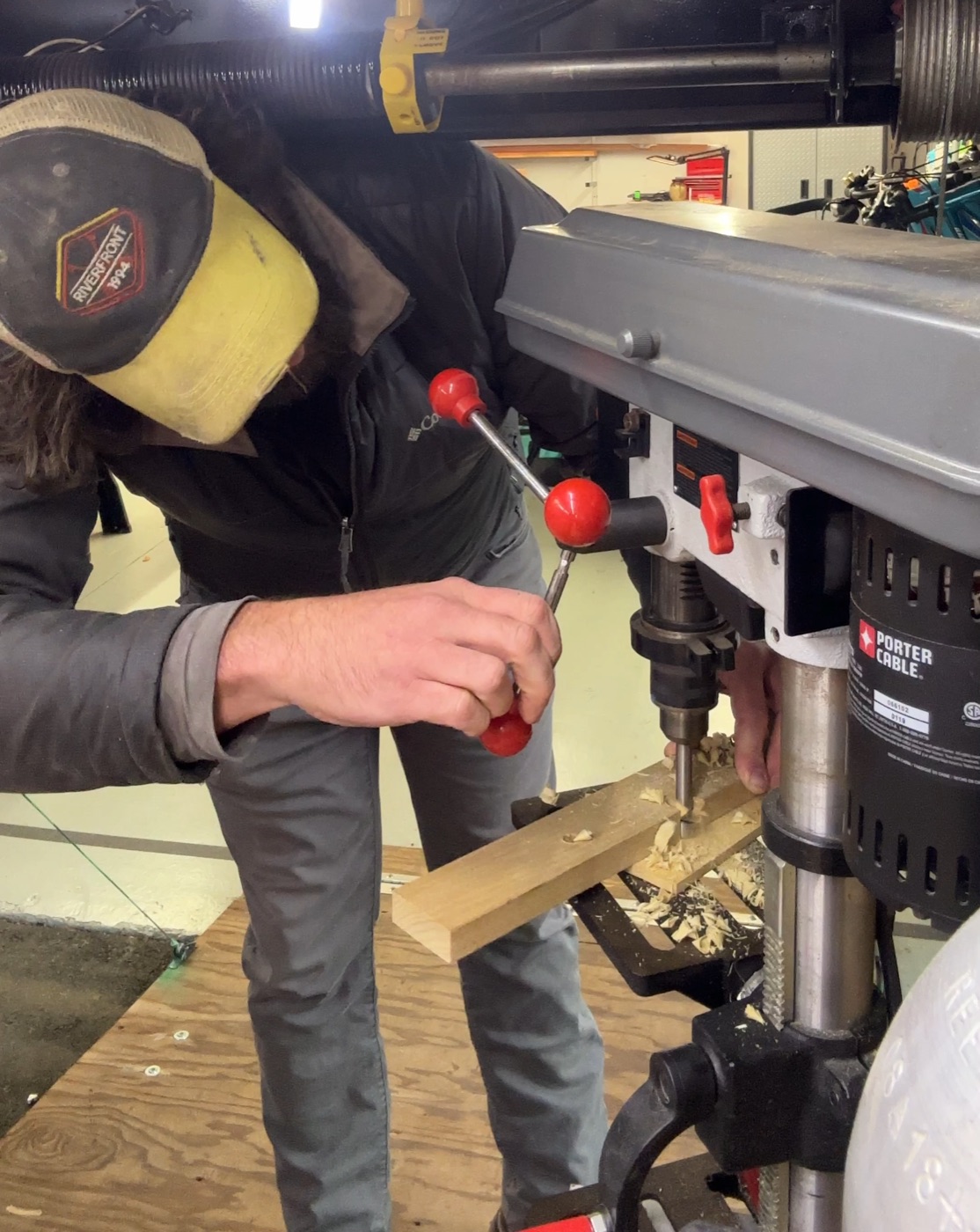 Closeup of drill press boring into wood