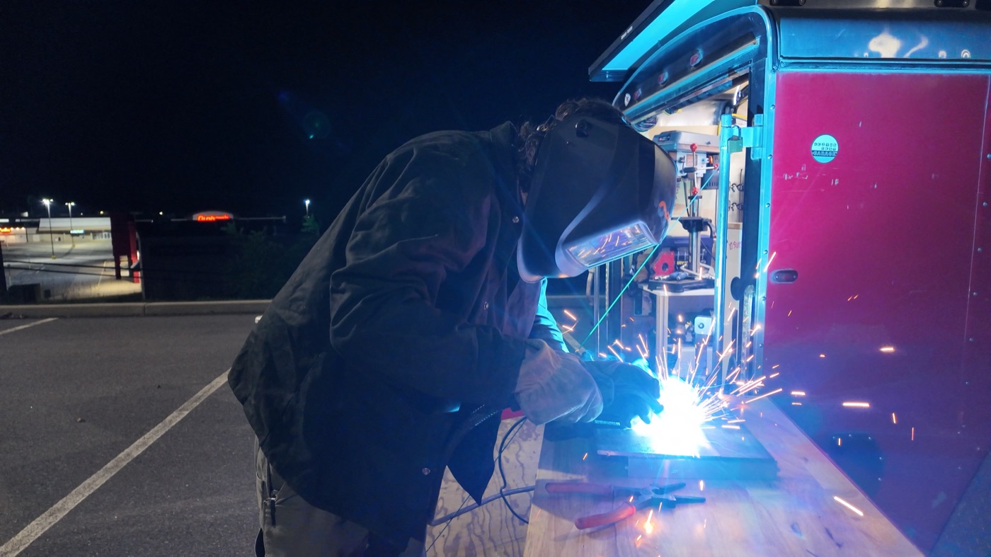 Welding at night at the trailer workbench